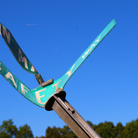 a green sign with white text on it