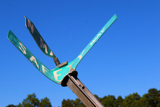 a green sign with white text on it