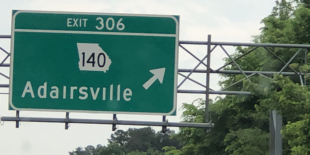 a green sign with white text