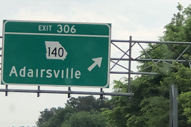 a green sign with white text