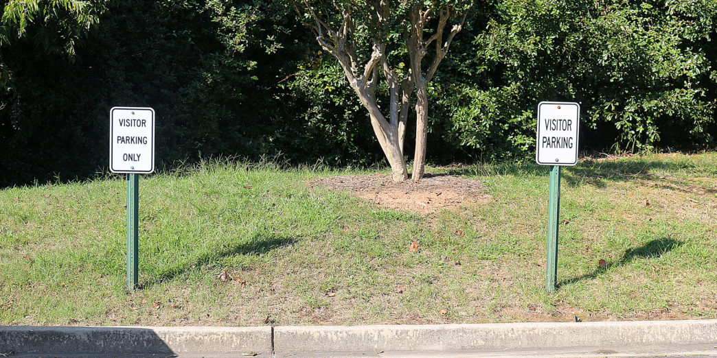 a two signs on the side of a road