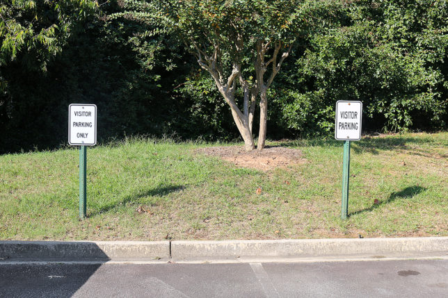 a two signs on the side of a road
