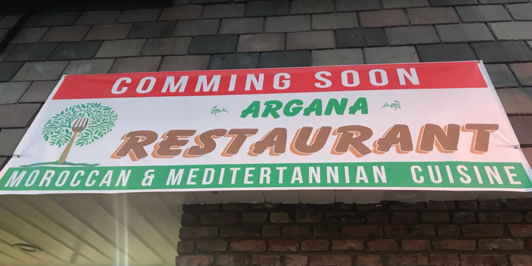 a sign on a brick wall