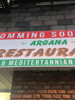 a sign on a brick wall