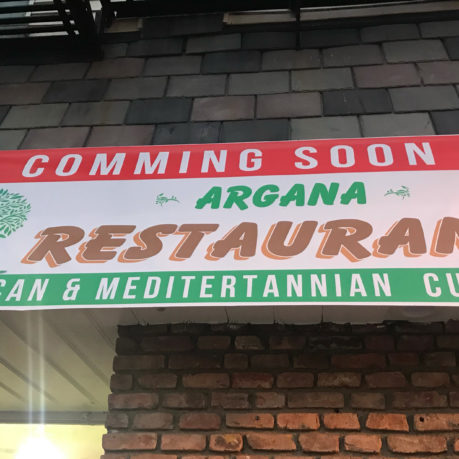 a sign on a brick wall