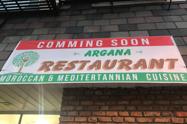 a sign on a brick wall