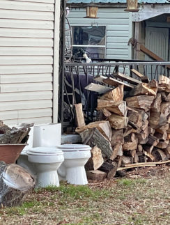 a stack of wood next to a building