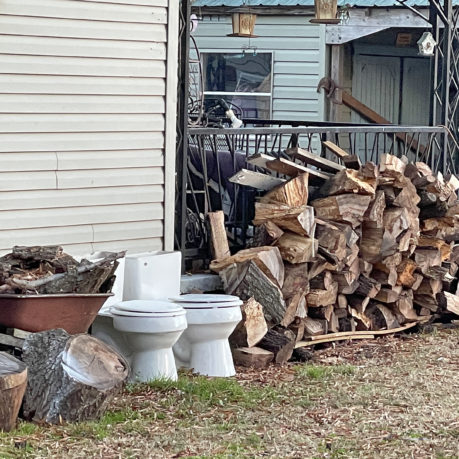 a stack of wood next to a building