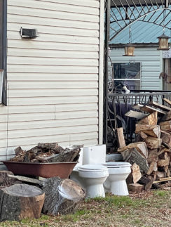 a house with a stack of wood