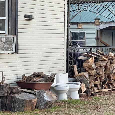 a house with a stack of wood