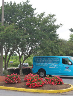 a blue van parked in front of a sign
