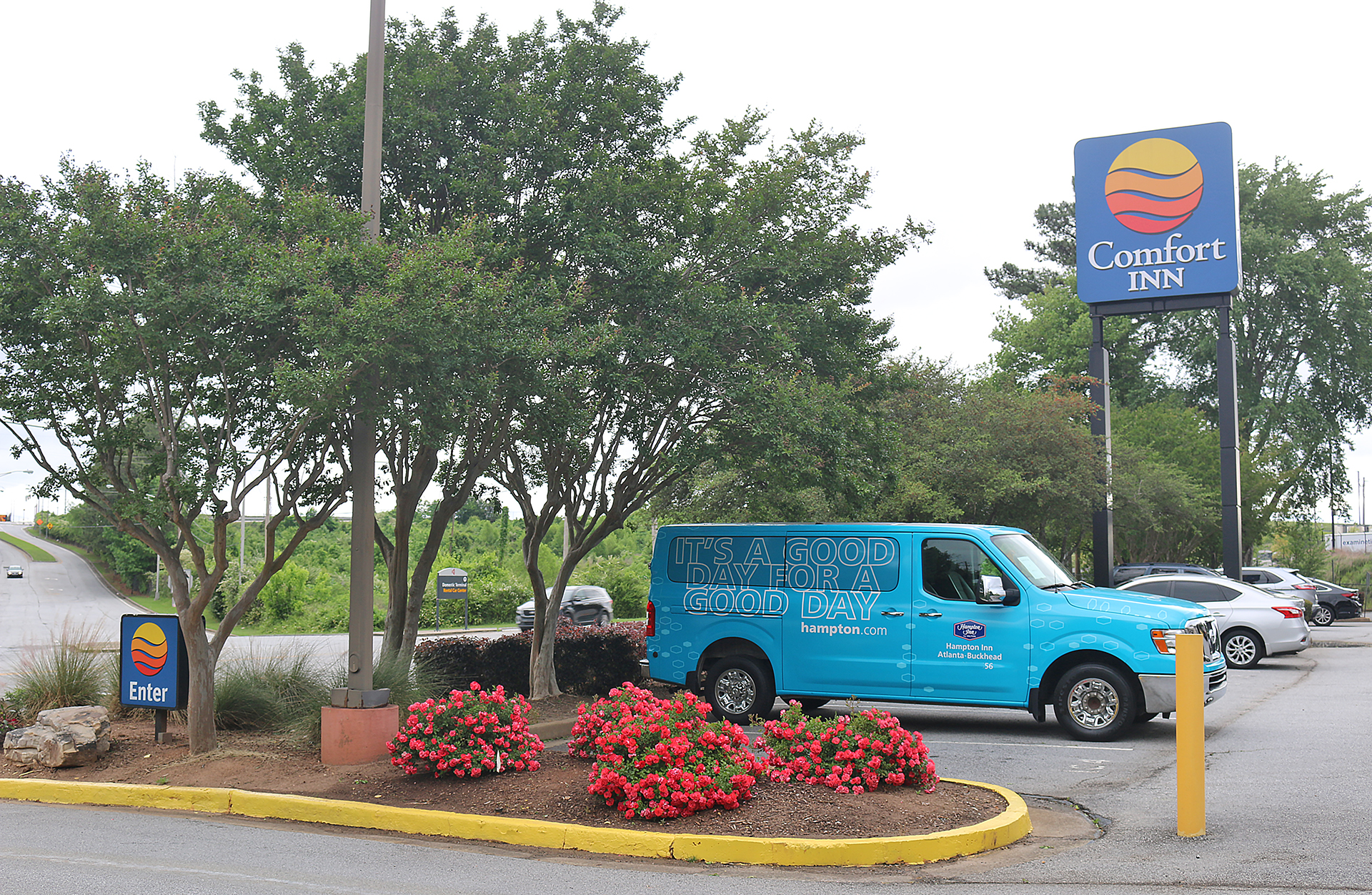 a blue van parked in front of a sign