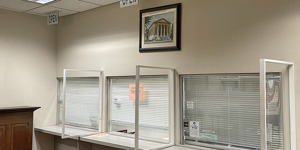 a row of empty white counters with closed windows