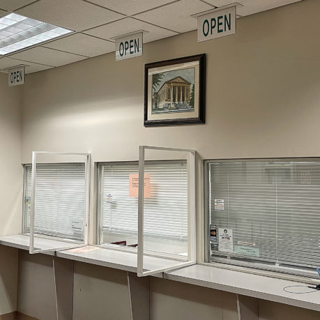 a row of empty white counters with closed windows