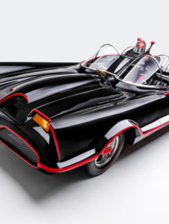 a black and red car with a red stripe