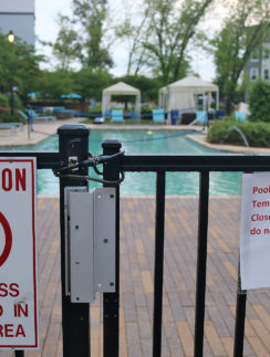 a pool with a sign on the fence