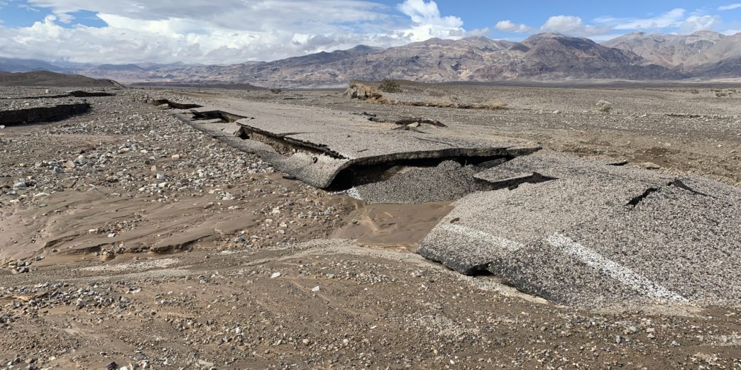 a rocky landscape with mountains in the background