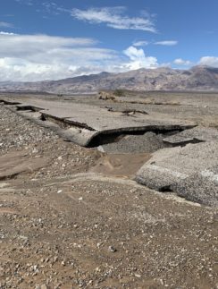 a rocky landscape with mountains in the background