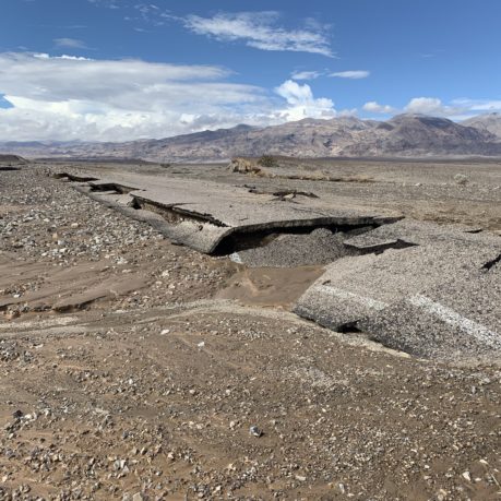a rocky landscape with mountains in the background