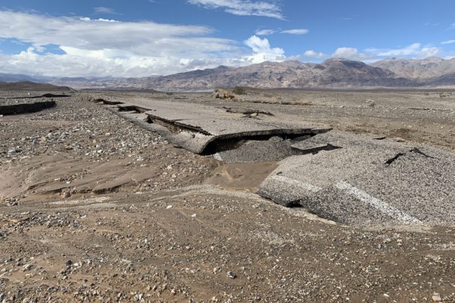 a rocky landscape with mountains in the background