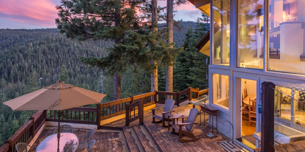 a deck with chairs and table on it