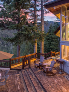 a deck with chairs and table on it