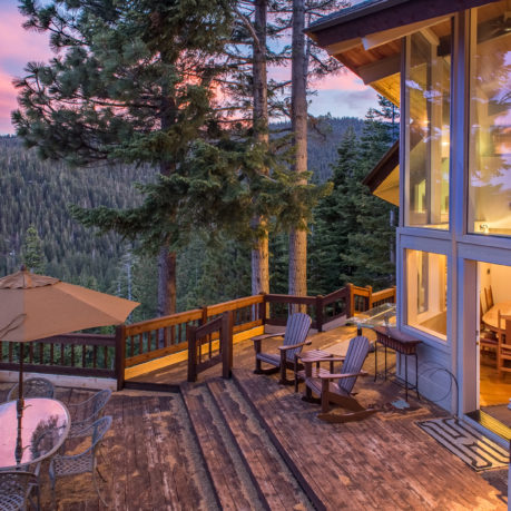 a deck with chairs and table on it