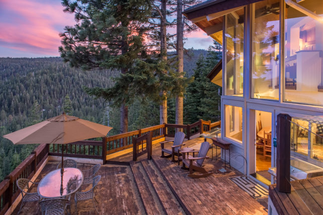 a deck with chairs and table on it