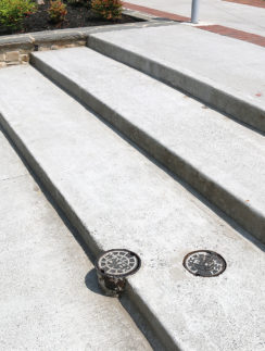 a concrete stairs with a drain