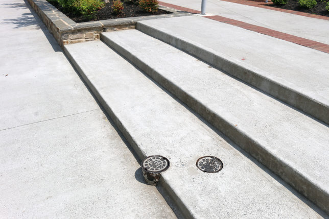 a concrete stairs with a drain