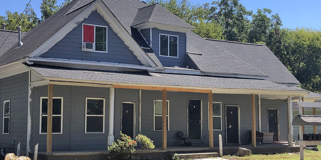 a house with a porch and a sidewalk