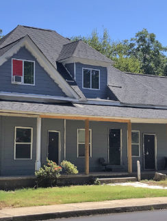 a house with a porch and a sidewalk