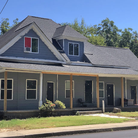 a house with a porch and a sidewalk