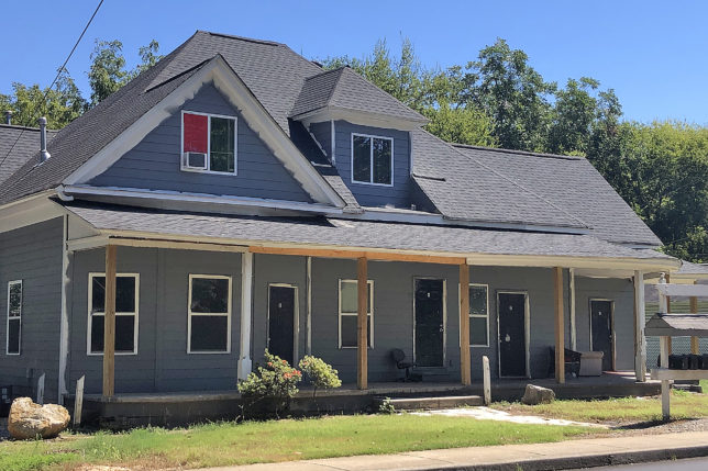 a house with a porch and a sidewalk