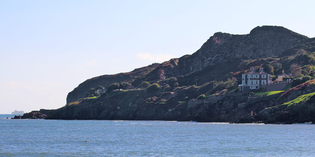 a house on a cliff by the water