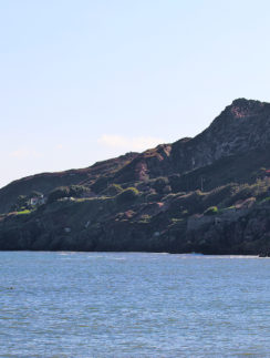 a house on a cliff by the water