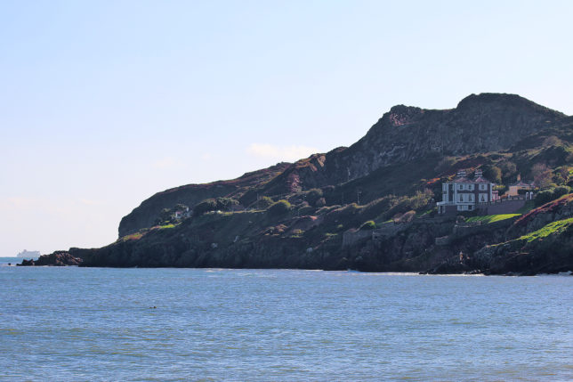 a house on a cliff by the water