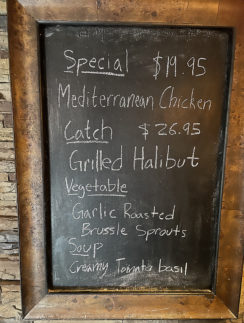 a chalkboard with a price list