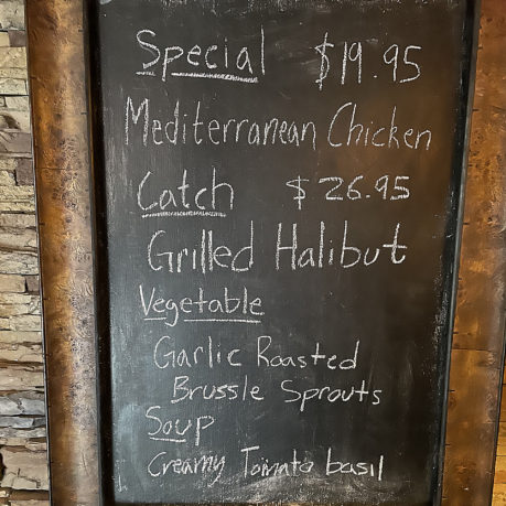 a chalkboard with a price list