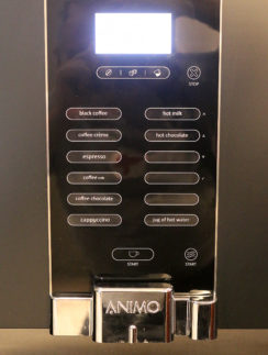 a black vending machine with buttons and buttons