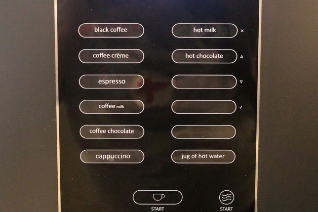 a black vending machine with buttons and buttons