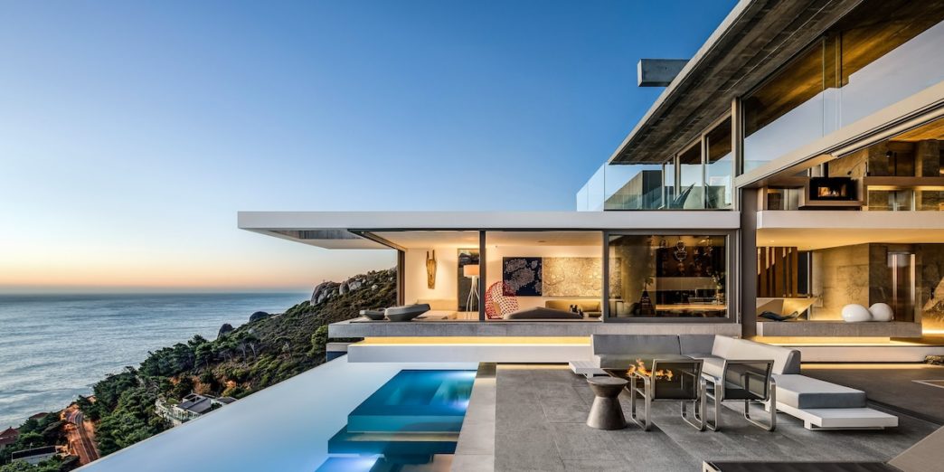 a house with a pool and a view of the ocean