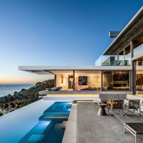 a house with a pool and a view of the ocean