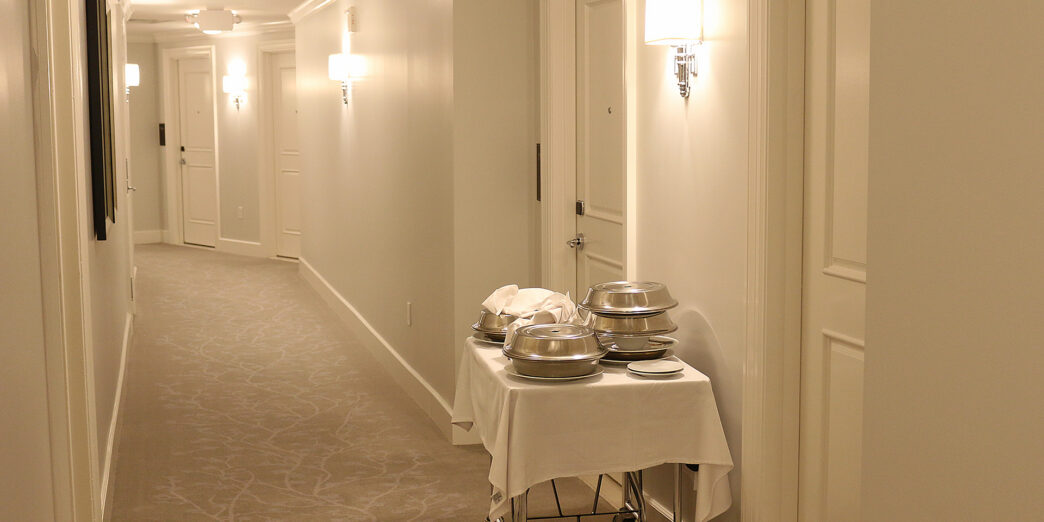 a hotel hallway with a cart with food on it