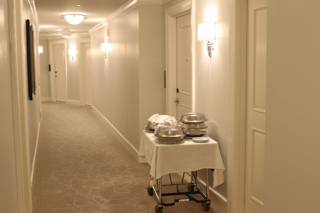 a hotel hallway with a cart with food on it