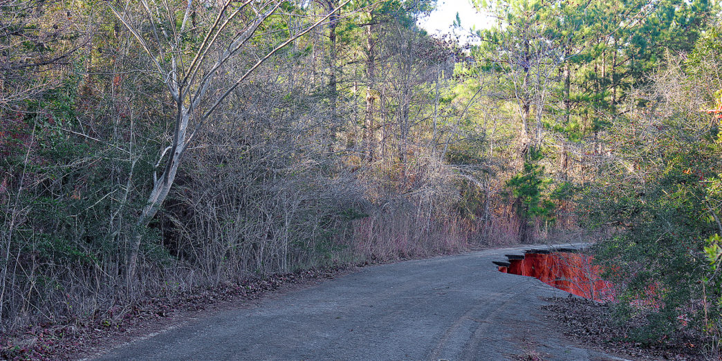 a road with red water in the middle