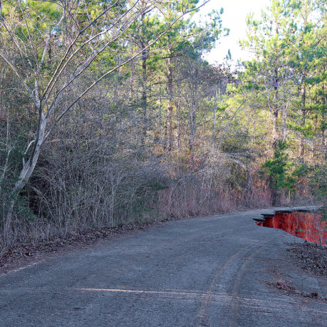 a road with red water in the middle
