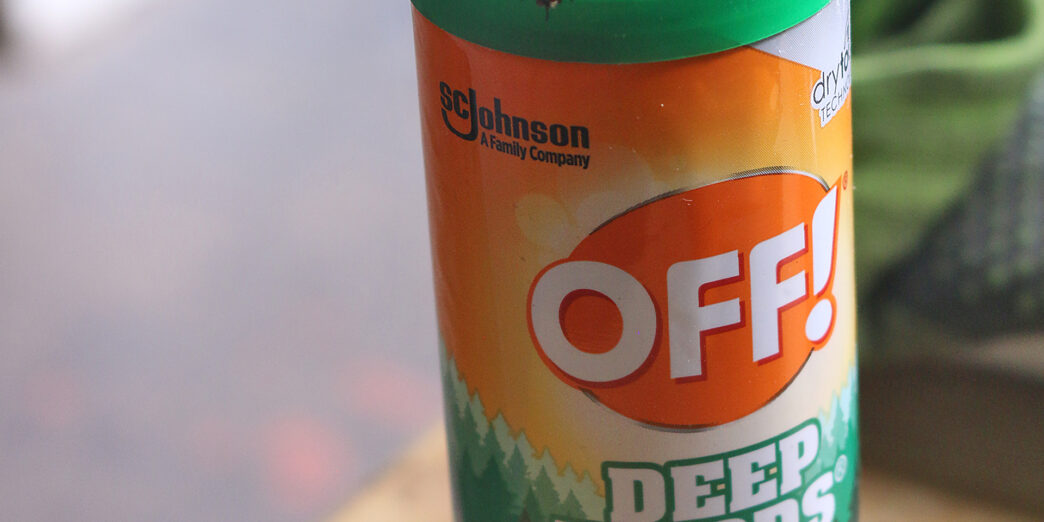 a insect repellent bottle with a bug on top