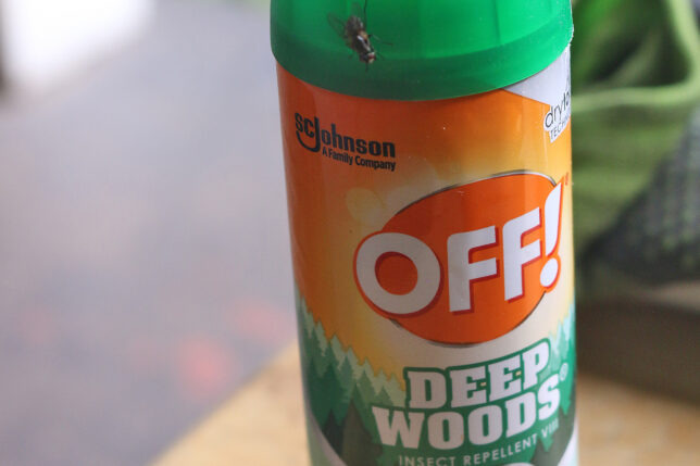 a insect repellent bottle with a bug on top