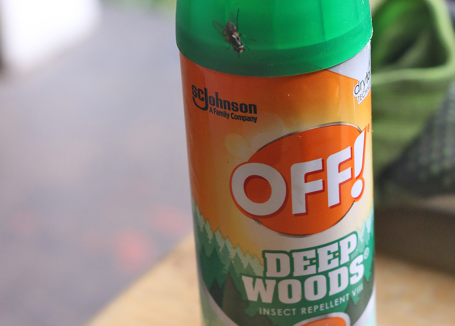 a insect repellent bottle with a bug on top